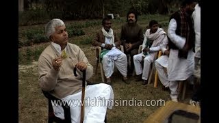 Lalu Prasad Yadav chews paan or betel leaf at a political meeting