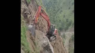 Constructing a road through treacherous mountain terrain.