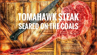 Hanging bone-in tomahawk steak over fire  then searing on the coals 🔥 shorts video