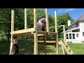 diy outdoor playset with two levels tarp roof twisty slide rock wall and swings