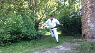 Guy in Martial Arts Uniform Flings Body over Fence
