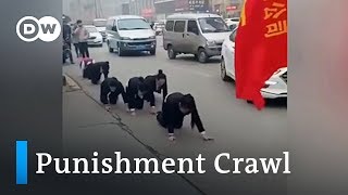 Chinese workers forced to go on punishment crawl on streets | DW News