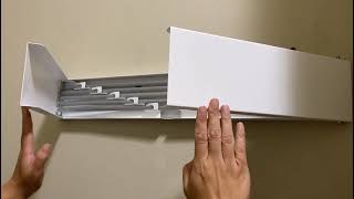 Install a wall mounted metal drying rack in laundry room