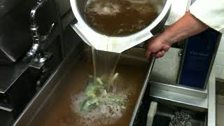 Pouring 6 Gallons Of Beef Pho Broth For Storage