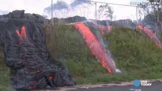 Raw video: Lava boils pond water, breaks through fence