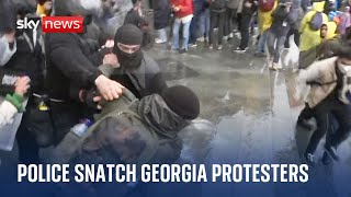 Protesters smash barriers at Georgia's parliament after divisive bill passed