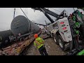 rotators lifting two train cars