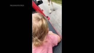 Giraffe at wildlife park picks up toddler from inside truck