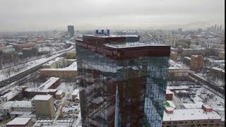 beautiful drone view of modern tower building standing on street of city