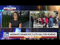 Migrants flood New York City Hall