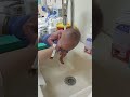 My newborn baby boy takes his first shower