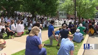 Staff at University of Rochester Medical Center kneel in silent reflection