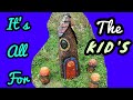 Chainsaw Carving A Gnome home and mushrooms.