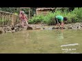 the poor girl and boy blocked the stream to catch fish and cooked together