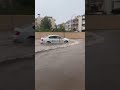 drivers drive through floodwaters in spain from storm dana