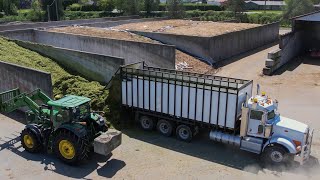 Raking chopping and packing grass silage with John Deere and peter-built.