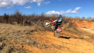 Honda CRF250X with CRF250R exhaust and cam jumping small hill