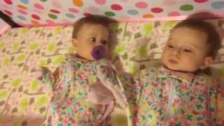 Baby girl steals pacifier from twin sister