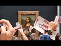 Man in wig throws cake at glass protecting Mona Lisa I ABC7