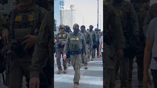 Federal immigration agents in full tactical gear were walking through downtown Chicago Sunday