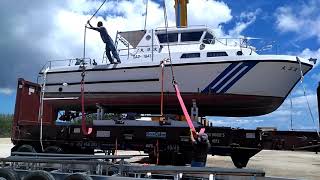 lifting boat from shipping rack onto trailer