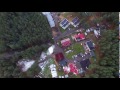 Vertical Flight Over Tv Tower, Houses And Forest - cutestockfootage.com