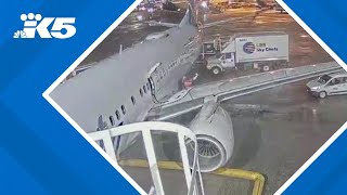 New video shows woman climbing onto wing of plane at SEA Airport