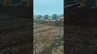 Bulldozers bulldozing process in rows