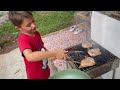 russian boy cooking pork on the grill