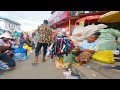 girl walks in africa open market ghana accra makola