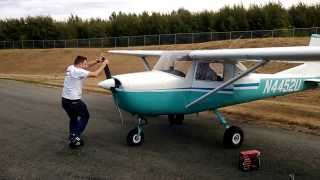 Hand Propping a Cessna 150.  DONT TRY THIS AT HOME!