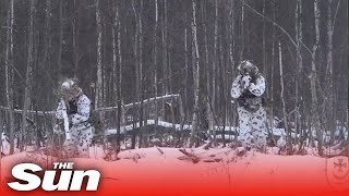 Ukrainian troops blend into their surroundings in winter camo before releasing fire