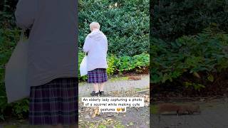 An elderly lady capturing a photo of a squirrel while making cute gestures 🐿️😍 #shorts #squirrel