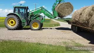 Delivering and unloading hay with an m140 John Deere