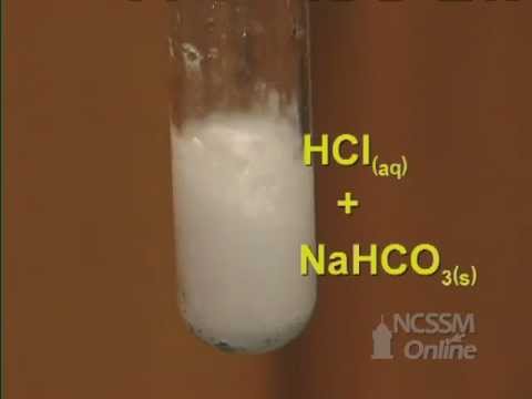What happens when hydrochloric acid reacts with sodium bicarbonate?