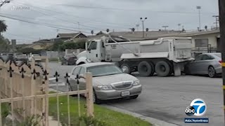 Man going through divorce rams dump truck into wife's home, parked cars