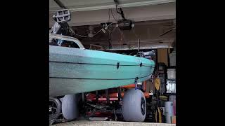 A Wilderness Systems kayak cart, a Nucanoe Pursuit and a kayak trailer.