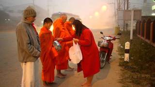 Monks chanting during alms round in Fang, Thailand