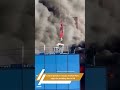 video crane operator rescues man from burning building in england