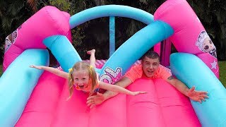 Stacy and dad fun playing with Inflatable water slide