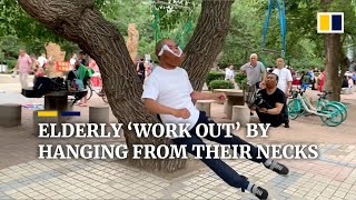 Elderly Chinese do ‘neck workouts’ by hanging from trees