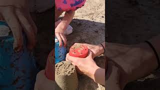 Kids having fun playing in the sand castle at the beach