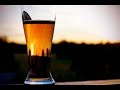 Pouring Beer in a Glass on a Beach at Sunset