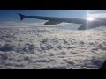 Airplane taking off & ascending above the clouds