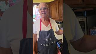 Charley cooking breakfast with his new apron on.