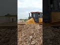 Incredible powerful bulldozer pushing soil in lake