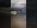 huge water cave with volcano like formations and fossil covered walls