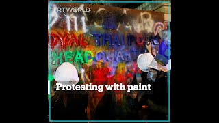 Thai protesters splash police building with paint