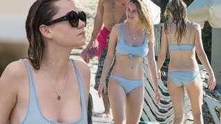 Immy goes for a swimmy! Waterhouse in a blue tie up bikini hits the beach during festive family holi