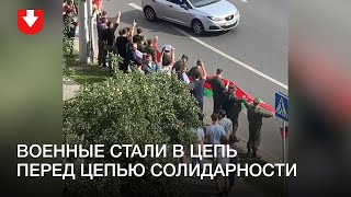 Военные с флагами стали впереди цепи соладирности в районе Института культуры